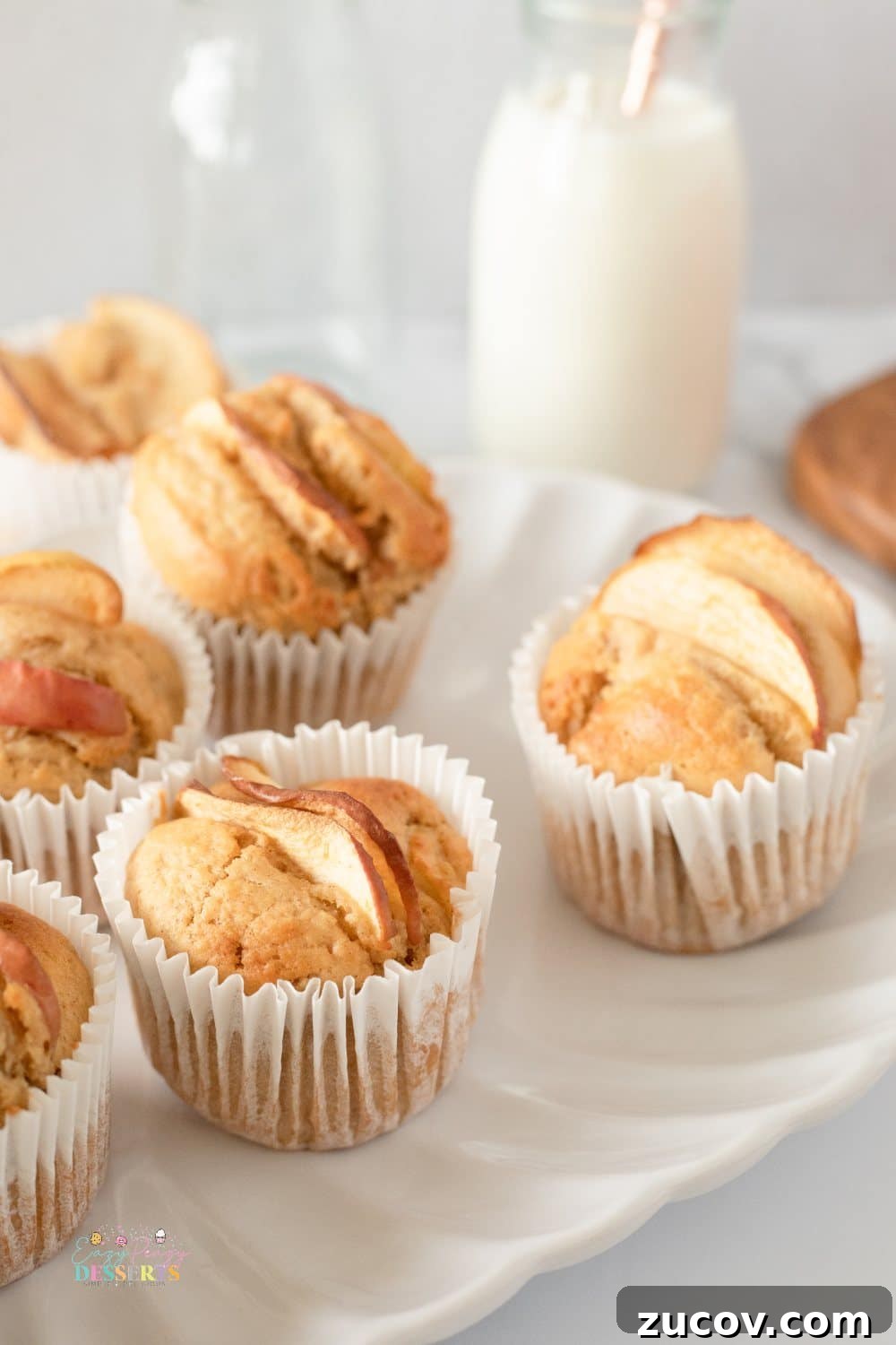 Warm Apple Cinnamon Muffins with Crumble Topping 6 Homemade easy apple muffins on a white plate