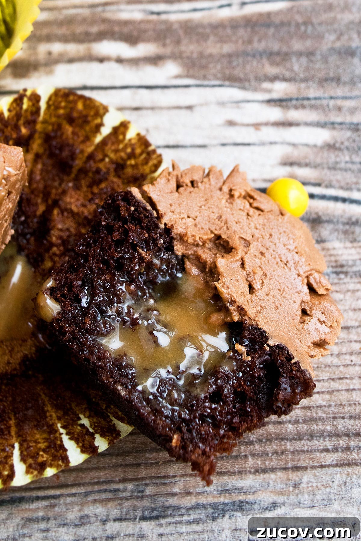 Mocha Coffee Cupcakes with Rich Espresso Frosting 5 Closeup Shot of Cupcake Cut in Half on Wood Background.