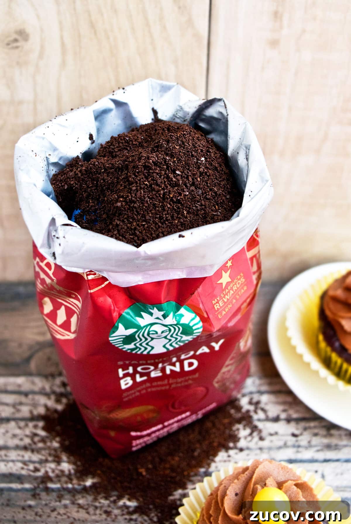 Mocha Coffee Cupcakes with Rich Espresso Frosting 6 Opened Bag of Starbucks Coffee on Wood Background.