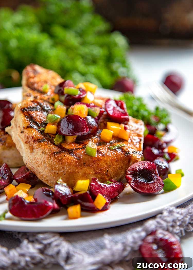 Dry rubbed with a sweet and spicy rub, these grilled pork chops are cooked to tender perfection and topped with a fresh cherry, pepper and honey salsa. Grilled Pork Chops and Cherry Salsa