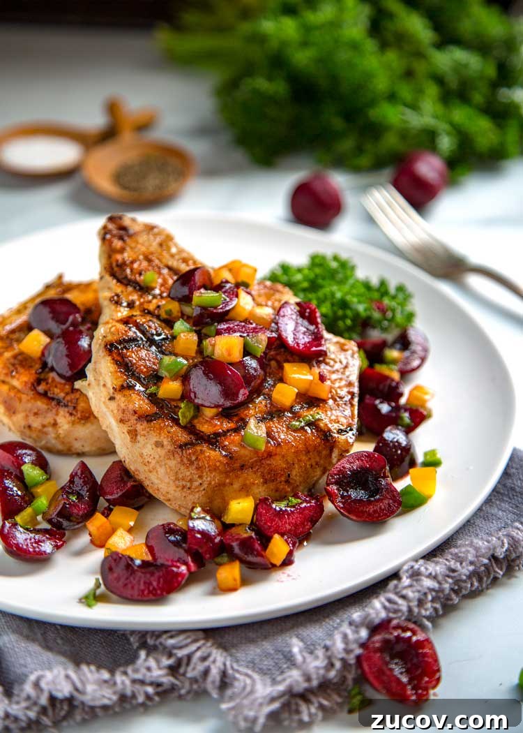 Dry rubbed with a sweet and spicy rub, these grilled pork chops are cooked to tender perfection and topped with a fresh cherry, pepper and honey salsa. Grilled Pork Chops and Cherry Salsa