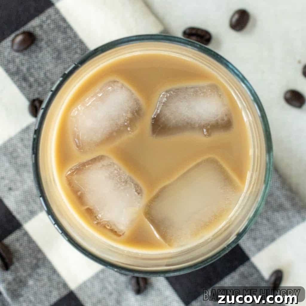 Creamy Vanilla Iced Coffee Recipe for Summer Refreshment 2 vanilla iced coffee in glass from overhead on plaid napkin