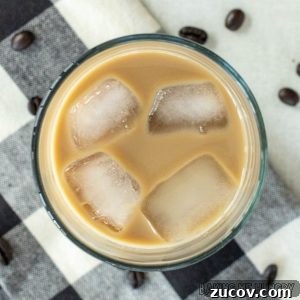 Creamy Vanilla Iced Coffee Recipe for Summer Refreshment 13 vanilla iced coffee in glass from overhead on plaid napkin