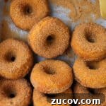 Donuts in the tray with a knife.