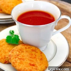 Tomato and Herb Broth Recipe for Flavorful Homemade Soup 5 Tomato drink in china cup on saucer.