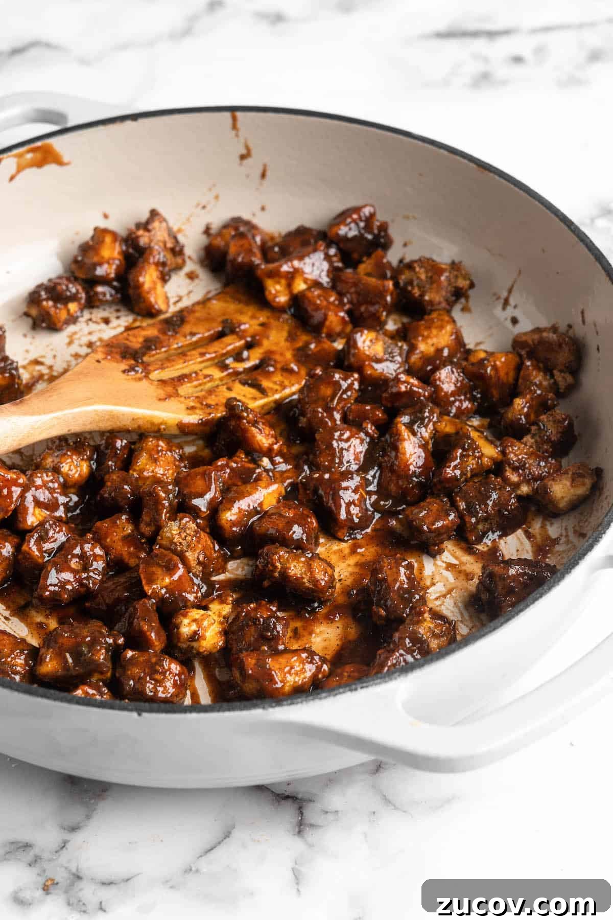 This Jamaican jerk tofu is the real deal! It's spicy, saucy, and just a little bit sweet. It's also super easy to make for a weeknight meal! Saucy Jamaican jerk tofu in skillet