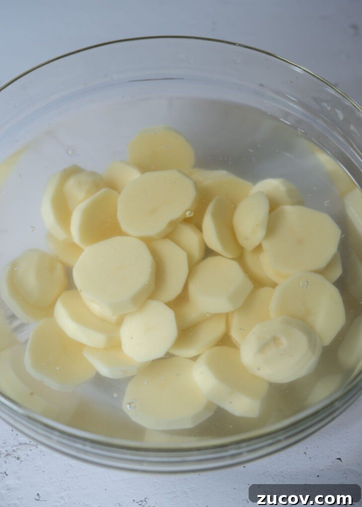 Spicy Korean Braised Potatoes (Maeun Gamja Jorim) 4 Potato slices soaking in water.