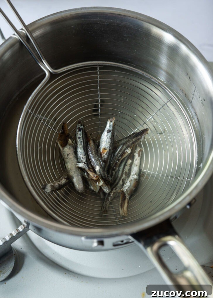 Spicy Korean Braised Potatoes (Maeun Gamja Jorim) 6 Discarding anchovies from the stock in a pot.
