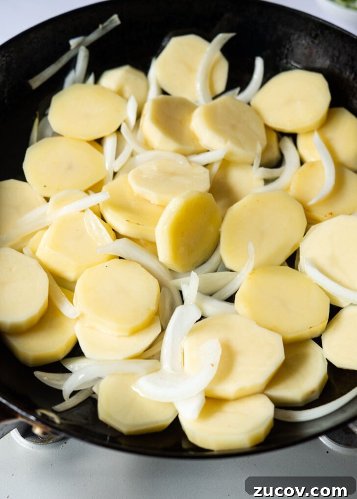 Spicy Korean Braised Potatoes (Maeun Gamja Jorim) 8 Potato and onion combined in a skillet.