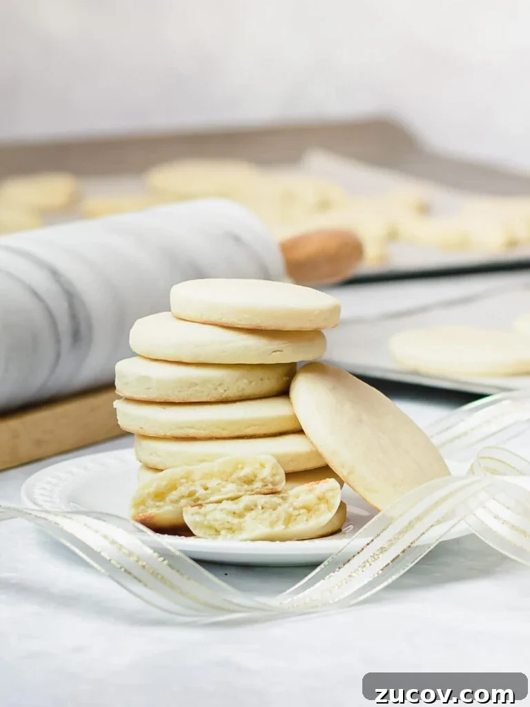 5-Minute Chocolate Ganache Recipe for Cakes, Glazes & Dips 9 stack of soft cut out sugar cookies on a white plate