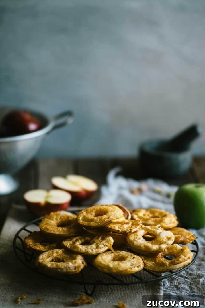 deep fried apple slices cooling on a rack
