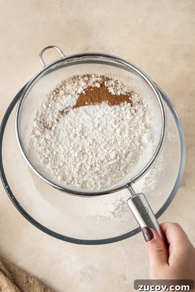 Ultimate Vegan Banana Bread Recipe You’ll Love 6 Sifting the dry ingredients into a bowl.