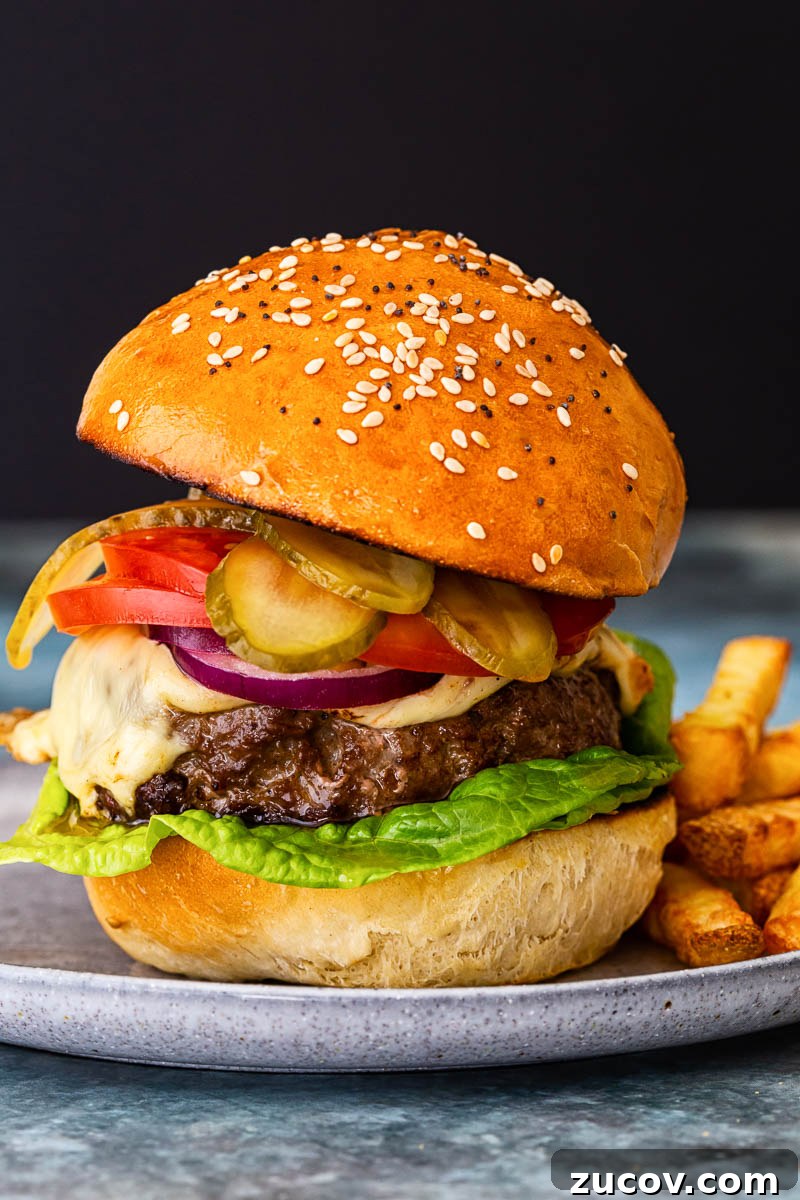 Juicy Homemade Burger Recipe for Perfect Grilling 2 a cheeseburger with onion, tomatoes and pickles