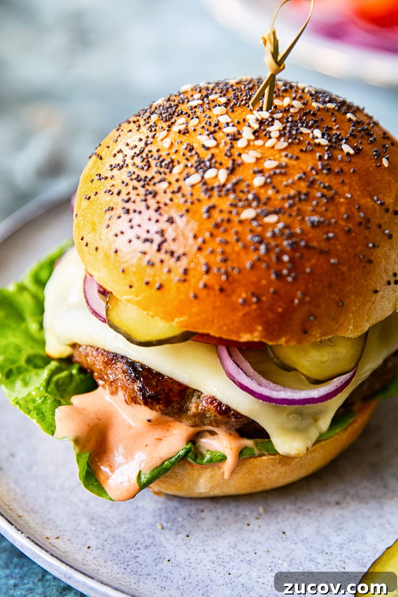 Juicy Homemade Burger Recipe for Perfect Grilling 4 top down view of a cheeseburger with sauce spilling out