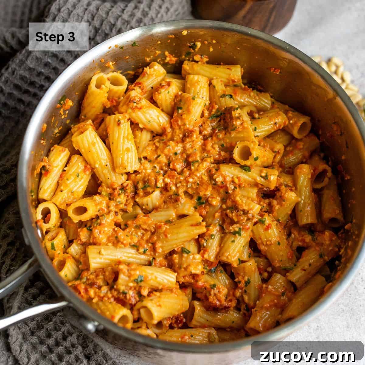 Roasted Red Pepper Pesto Recipe for Pasta, Sandwiches & Dips 5 Sauce pan with pasta and red pepper pesto mixed in.