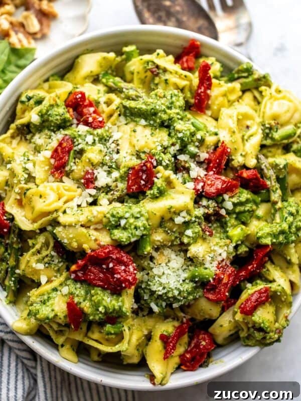 Roasted Red Pepper Pesto Recipe for Pasta, Sandwiches & Dips 7 Tortellini with pesto in a white bowl up close.