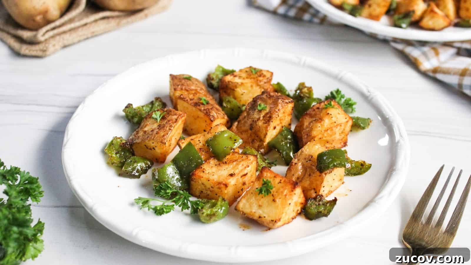 17 Comforting Side Dishes That Steal the Show 12 Air-fried potato cubes with diced green bell peppers on plate.
