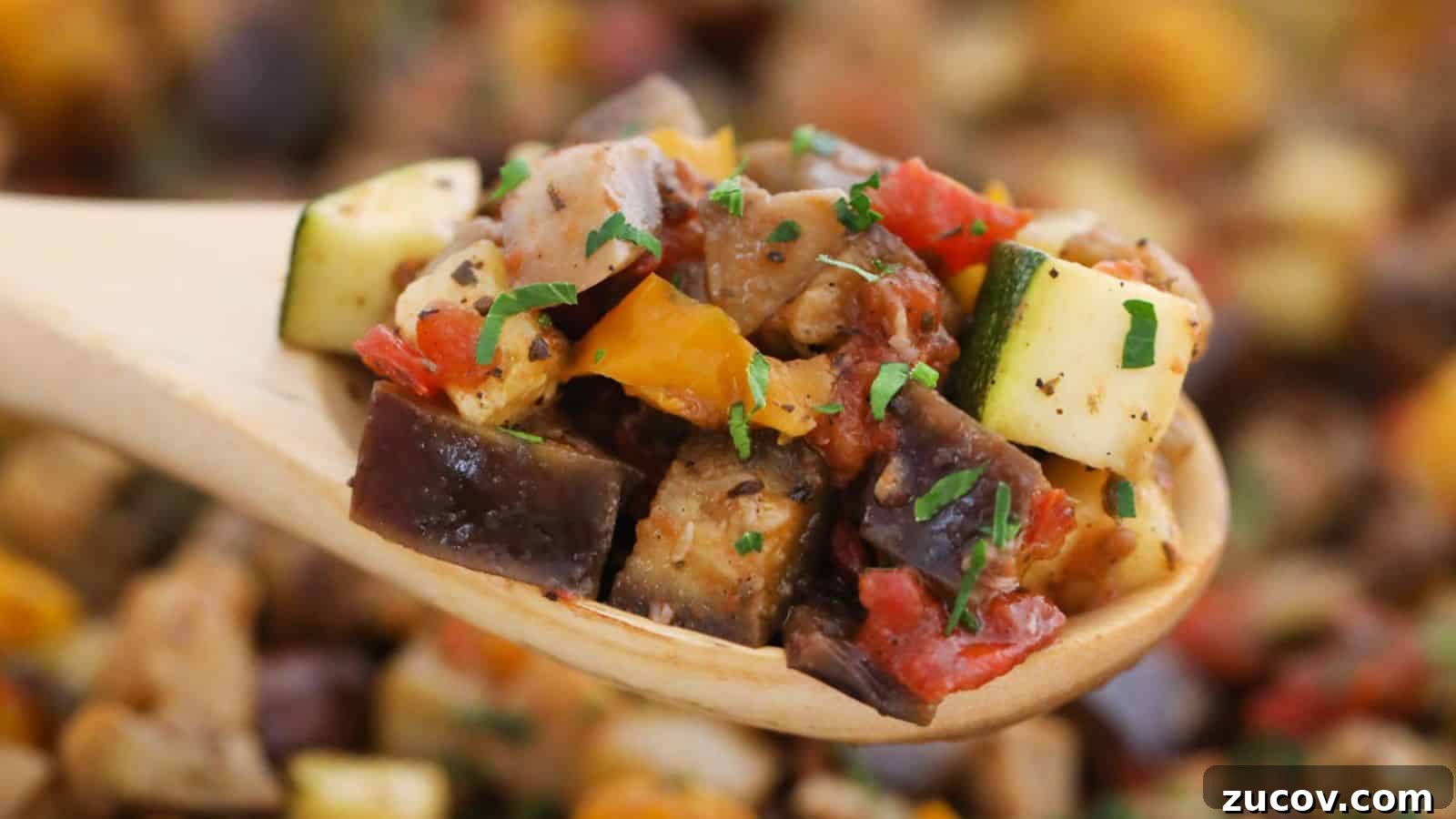 17 Comforting Side Dishes That Steal the Show 14 Close-up of a wooden spoon holding ratatouille, featuring chopped zucchini, bell peppers, and eggplant, garnished with parsley.