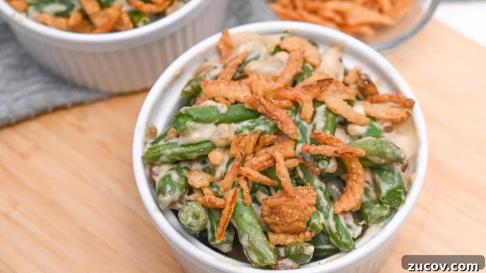 17 Comforting Side Dishes That Steal the Show 16 A ramekin of green bean casserole topped with crispy fried onions, served on a wooden table.