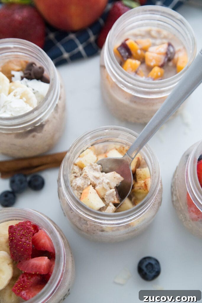 Creamy Overnight Oats: 5 Simple Recipes for Busy Mornings 2 Overnight Oats in Mason Jars with 5 different toppings. The apple cinnamon one has a spoon inside.