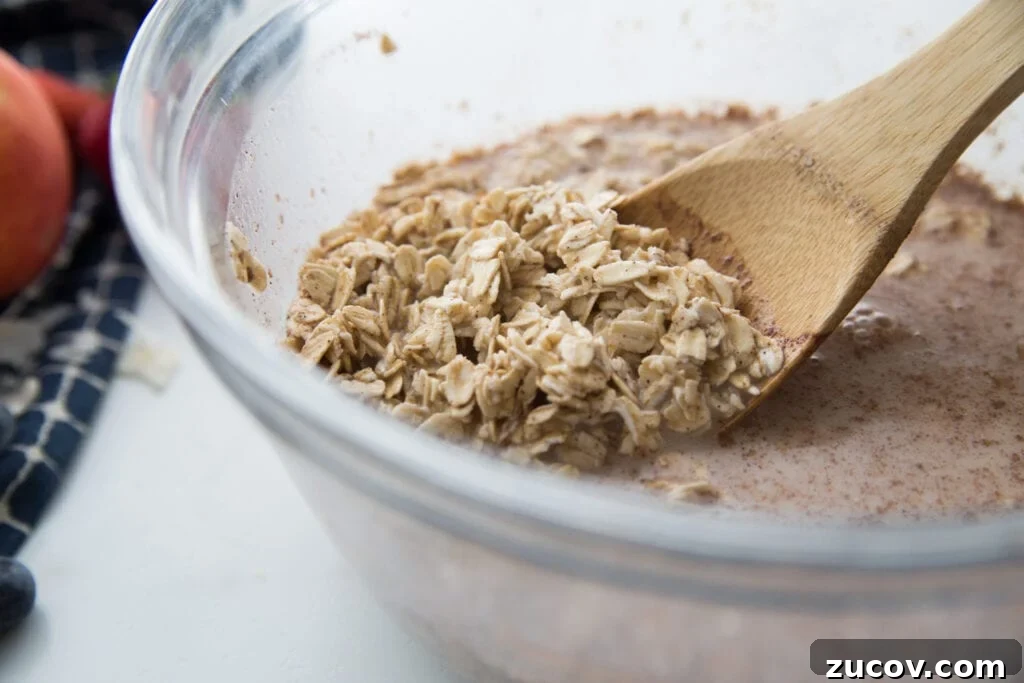 Creamy Overnight Oats: 5 Simple Recipes for Busy Mornings 4 A bowl of oats, almond milk, and cinnamon with a wooden spoon