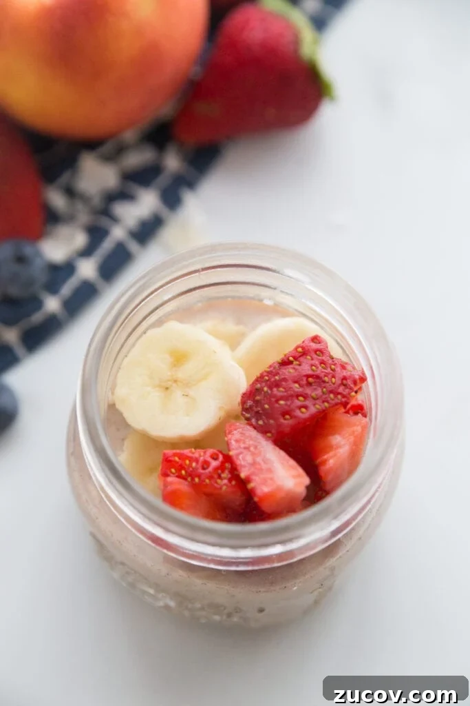 Creamy Overnight Oats: 5 Simple Recipes for Busy Mornings 8 Strawberry banana overnight oats sitting next to a blue napkin with fruit on top