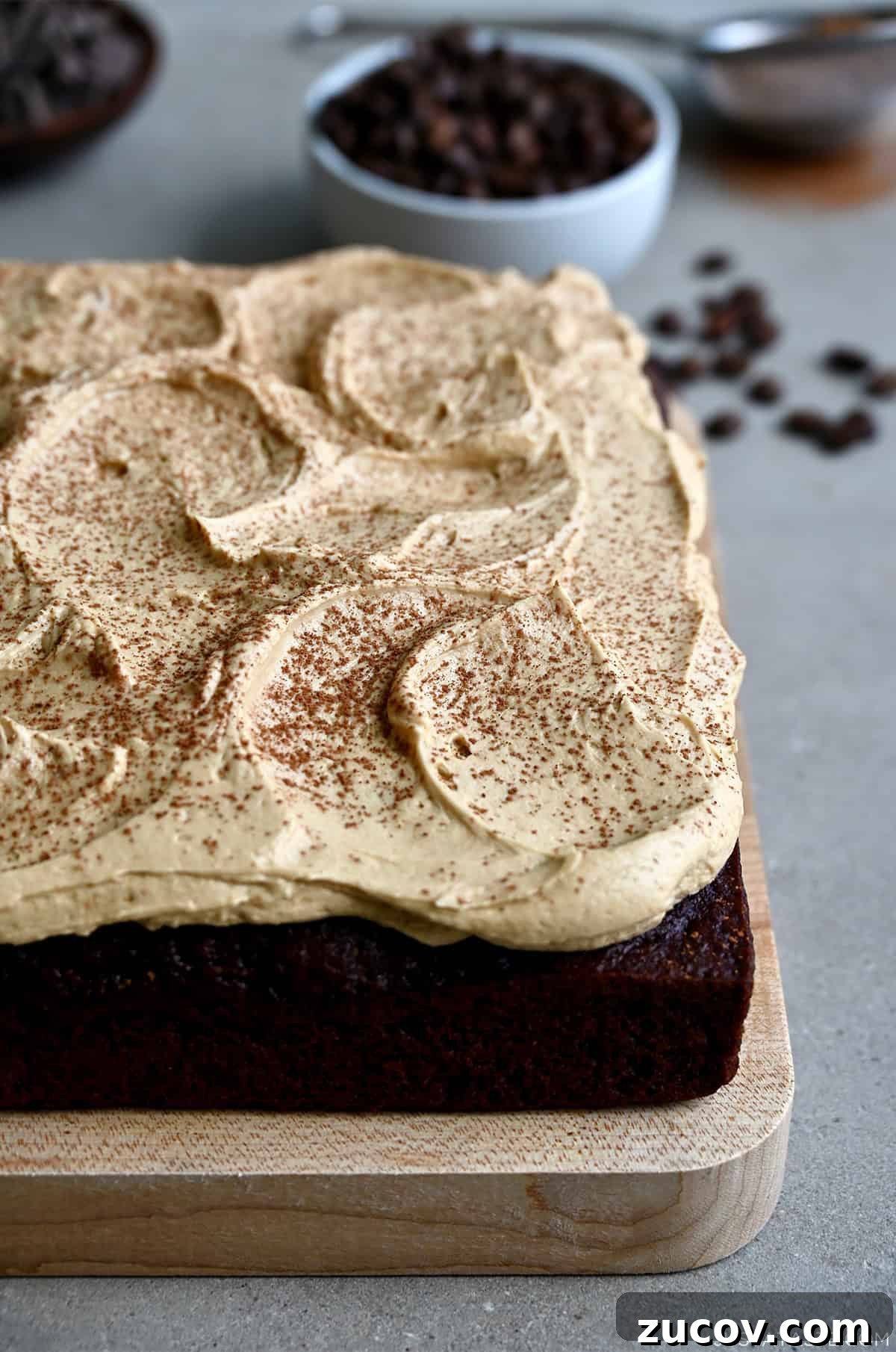 5-Minute Coffee Buttercream Frosting Recipe 2 A thick layer of coffee buttercream frosting dusted with cocoa powder atop a chocolate sheet cake.