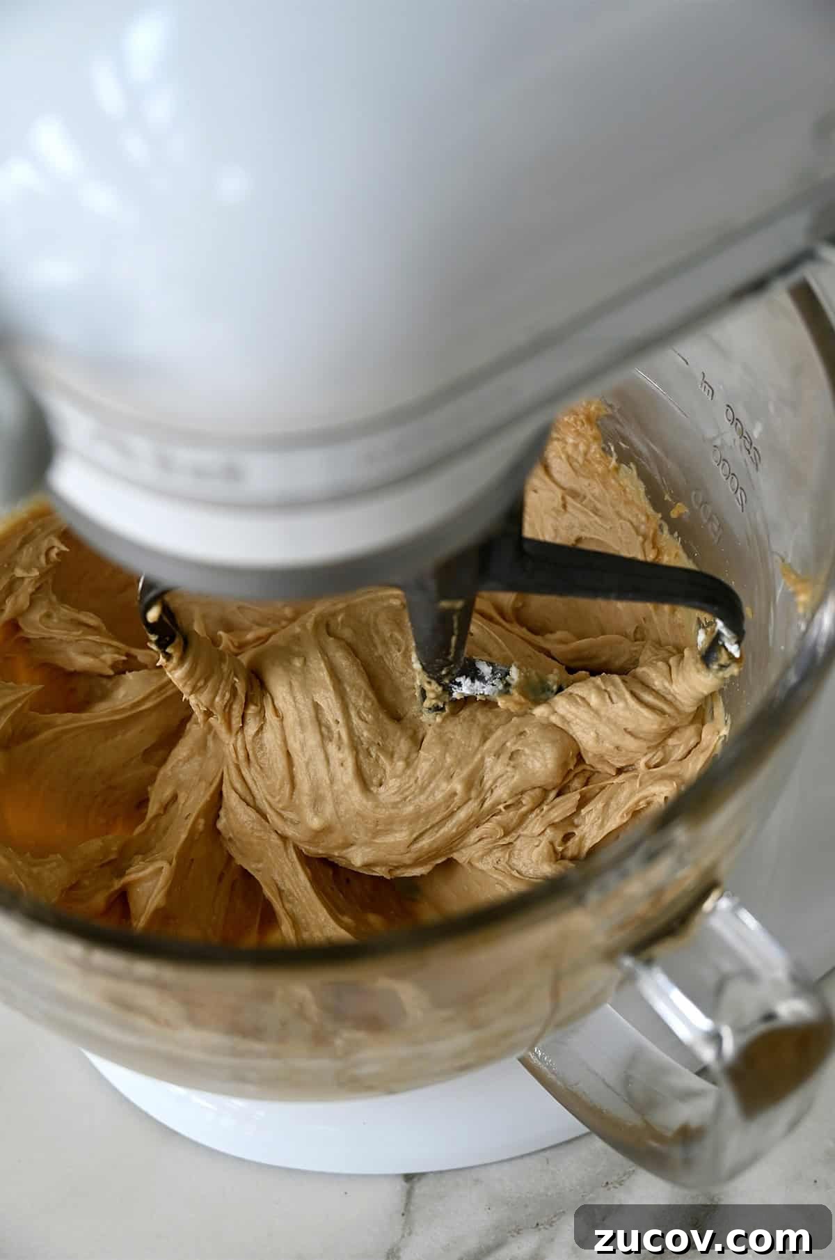 5-Minute Coffee Buttercream Frosting Recipe 8 A stand mixer bowl containing easy coffee buttercream frosting.