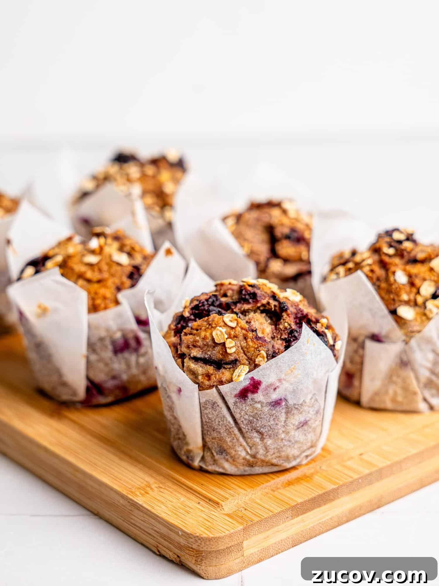 Banana Blackberry Muffins with 5 Simple Ingredients 11 Six Blackberry Muffins on a wooden board.