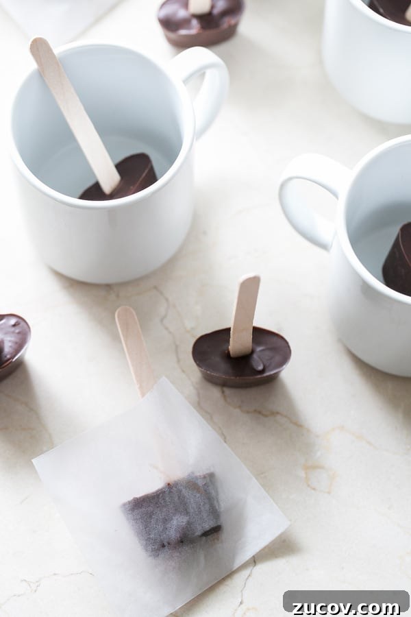 Delicious Hot Chocolate Sticks: Melt-In-Mug Cocoa Treats 4 Hot chocolate on a stick, surrounded by mugs.