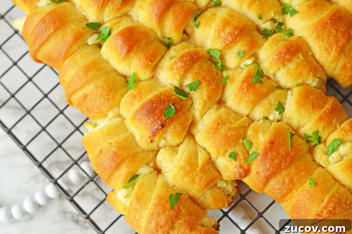Close-up of Pull-apart crescent Christmas tree garnished with parsley on wire rack.