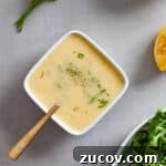 A small white bowl of preserved lemon vinaigrette topped with chopped parsley.
