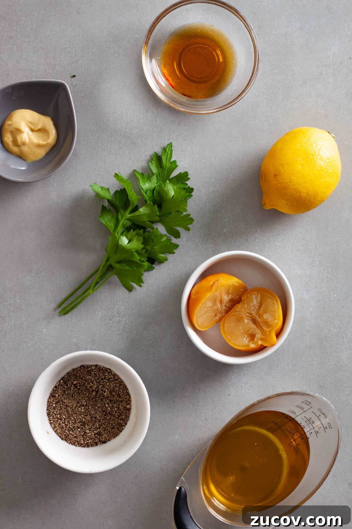 Preserved Lemon Vinaigrette Recipe for Bright, Tangy Salads 3 Ingredients for a preserved lemon vinaigrette on a gray table.