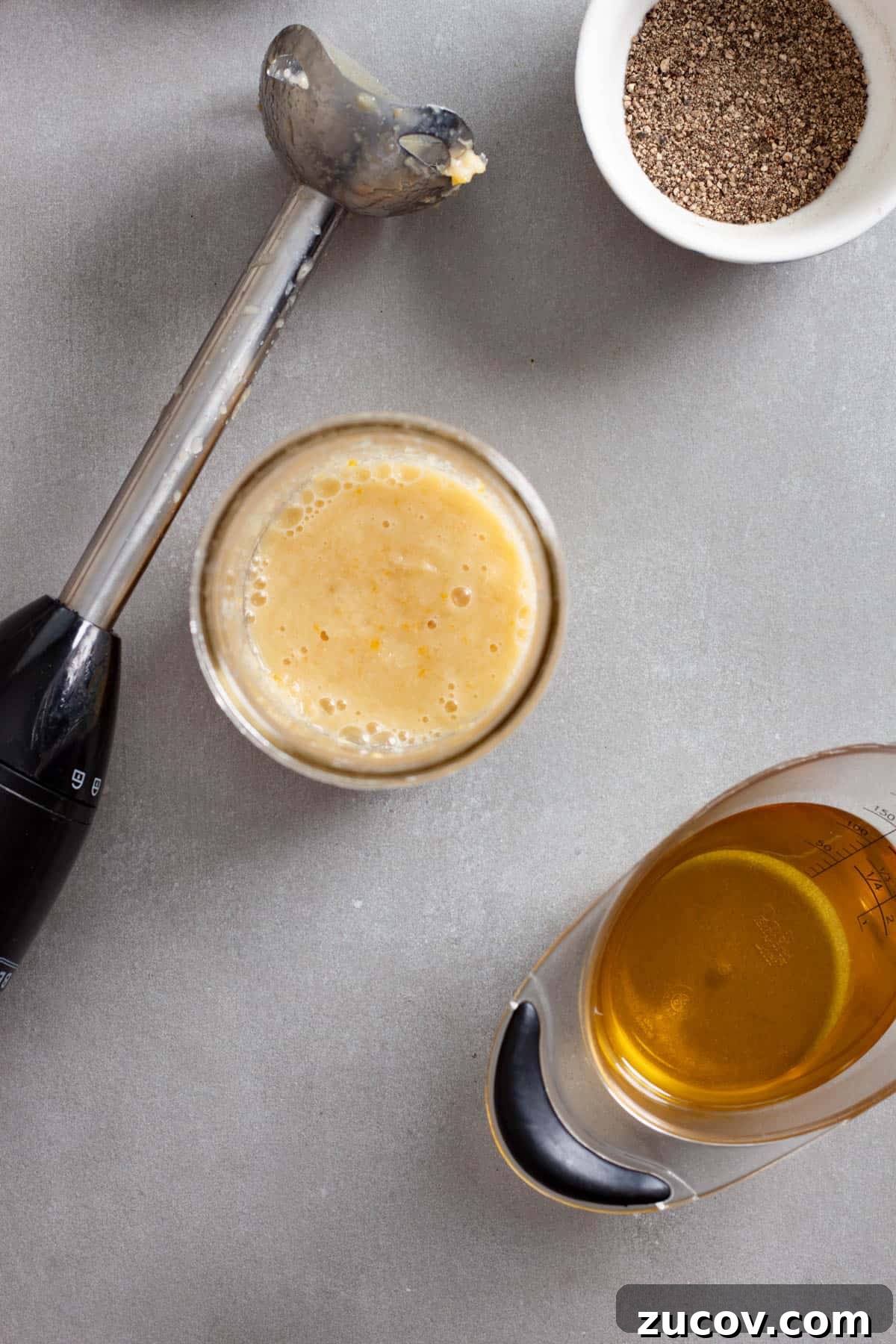 Preserved Lemon Vinaigrette Recipe for Bright, Tangy Salads 5 Preserved lemon vinaigrette without the oil added in a mason jar with a hand blender to the side.