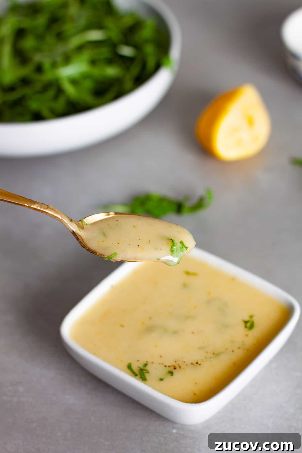 Preserved Lemon Vinaigrette Recipe for Bright, Tangy Salads 8 A spoonful of preserved lemon vinaigrette above a bowl of the dressing.