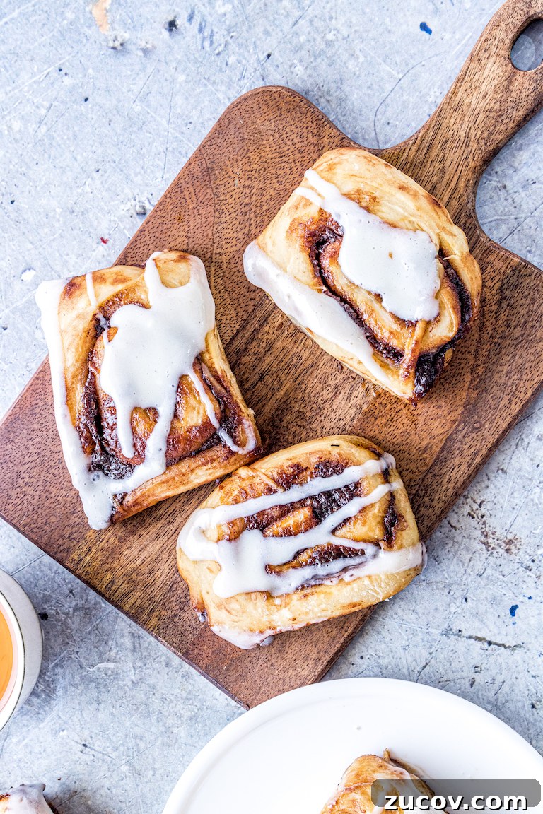 Nutella Pumpkin Cinnamon Rolls with Gooey Chocolate Swirl 2 three nutella pumpkin cinnamon rolls on a serving board