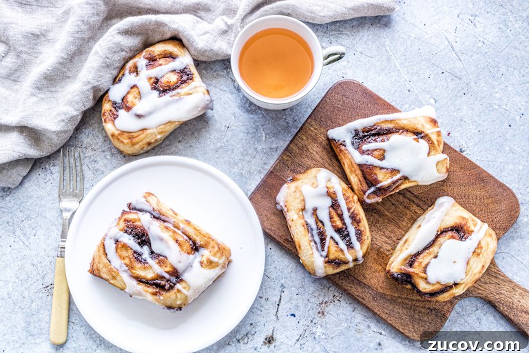 Nutella Pumpkin Cinnamon Rolls with Gooey Chocolate Swirl 7 nutella pumpkin cinnamon rolls served with a cup of tea