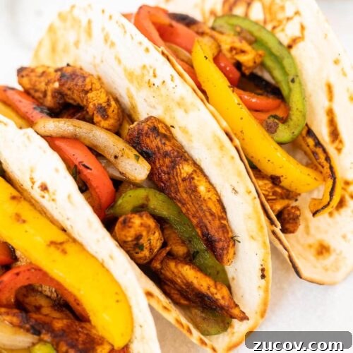February Blackstone Chicken Recipes: What to Grill This Month 11 Three flour tortillas filled with seasoned Blackstone Chicken Fajitas—tender chicken strips, sautéed red, yellow, and green bell peppers and onions.