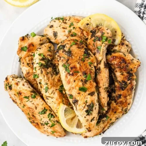 February Blackstone Chicken Recipes: What to Grill This Month 12 Cooked Chicken Tenders on a plate with slice lemons