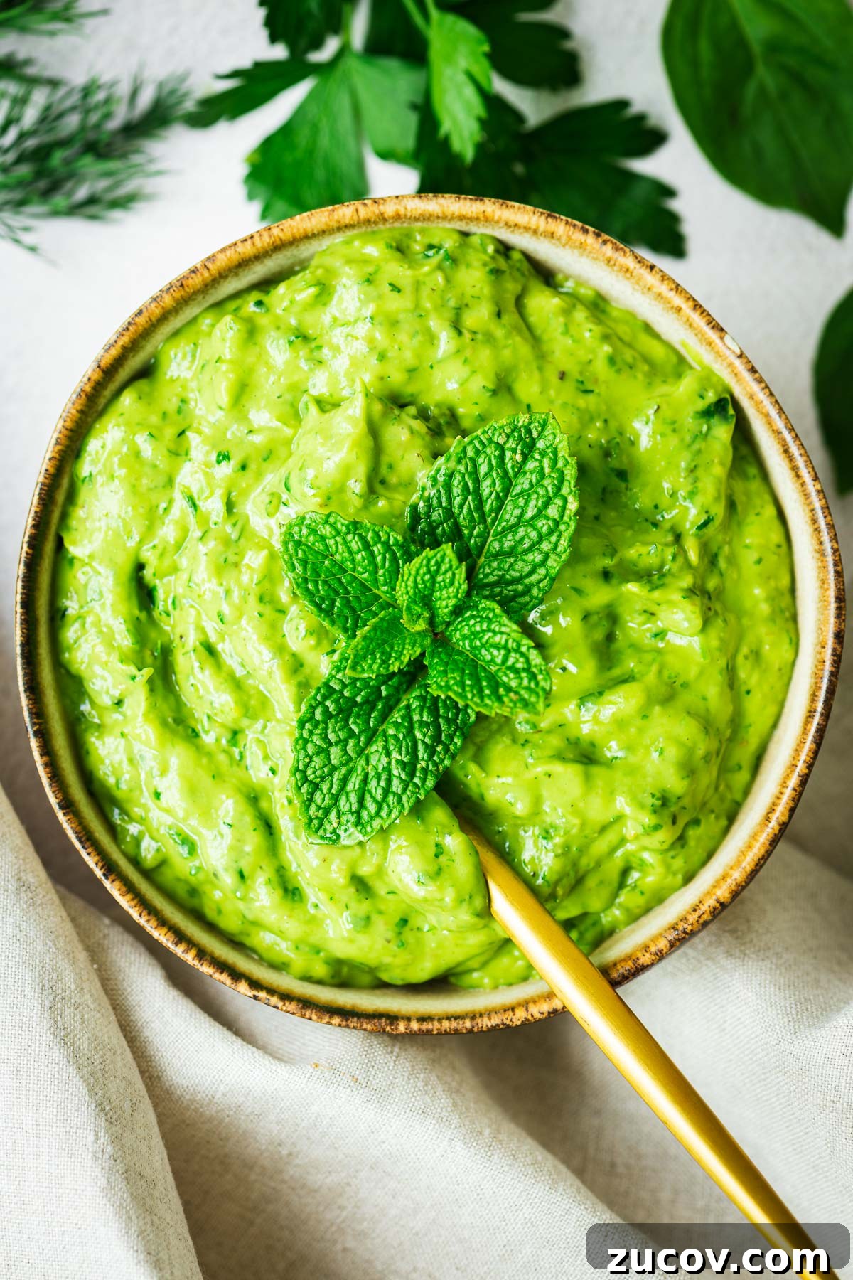 Creamy Avocado Green Goddess Dressing Recipe for Salads and Bowls 2 A small bowl with avocado green goddess dressing viewed from above.