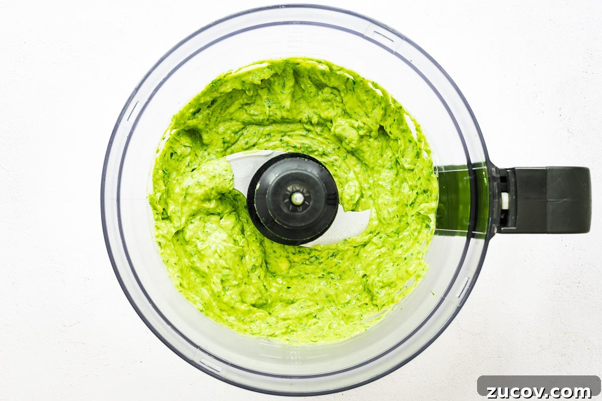 Creamy Avocado Green Goddess Dressing Recipe for Salads and Bowls 6 Smooth and creamy vegan green goddess sauce in a food processor bowl.