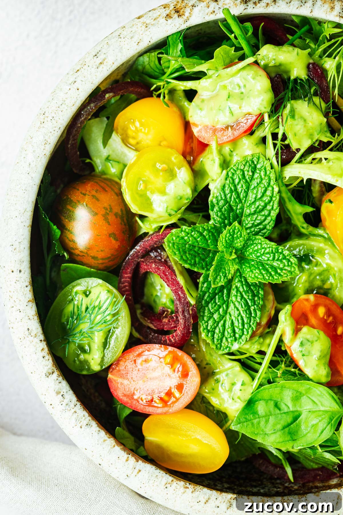 Creamy Avocado Green Goddess Dressing Recipe for Salads and Bowls 7 A close-up of a simple salad will avocado green goddess salad dressing.