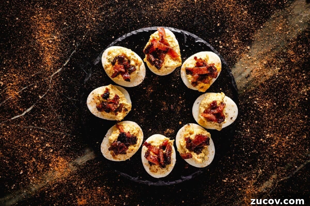 Sweet Rub Recipes to Elevate Your Dinner Menu 3 A round, black plate with deviled eggs in a circle.