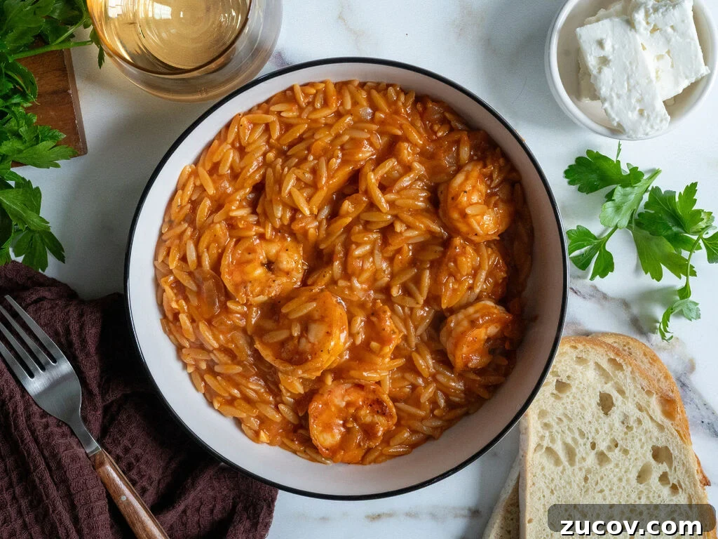 Garides Youvetsi: Greek Shrimp with Orzo Recipe 2 Garides youvetsi, Greek shrimp with orzo. In a white bowl surrounded by feta, bread, a fork, a napkin and wine.