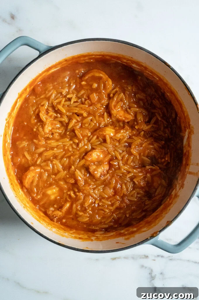 Garides Youvetsi: Greek Shrimp with Orzo Recipe 10 shrimp youvetsi in a blue sauce pot.