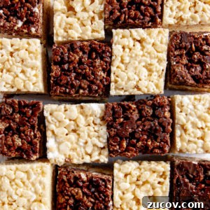 Chocolate and Vanilla Layered Rice Krispie Treats 4 Chocolate-Vanilla Layered Rice Krispie Treats arranged like a checkered board pattern on white parchment paper.