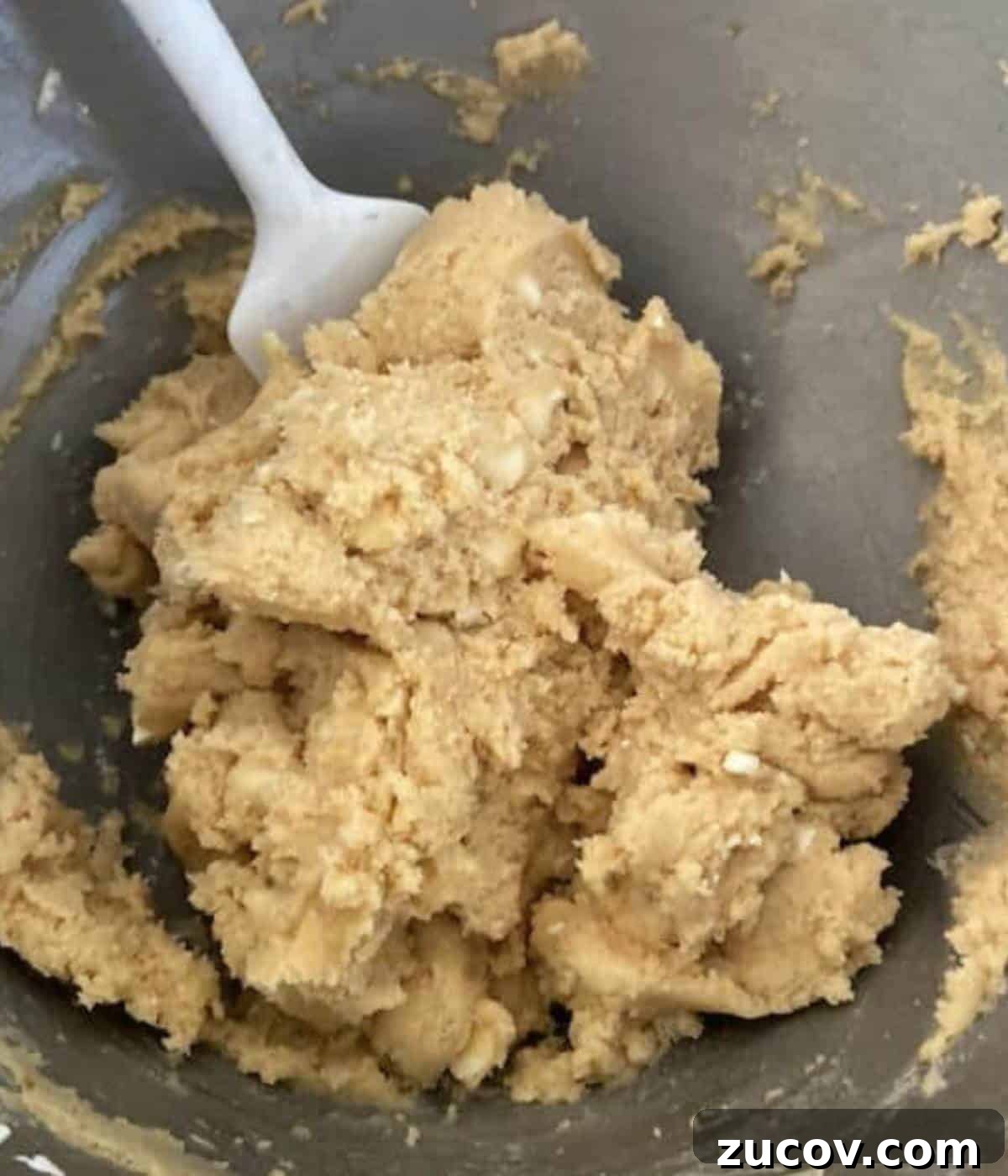 Chewy White Chocolate Chip Cookie Recipe for Perfect Bakes 6 Cookie dough batter with white chocolate chips in bowl.