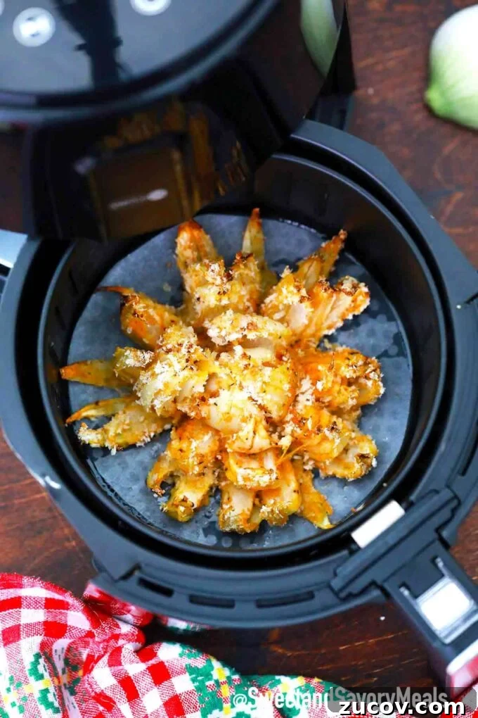 Crispy Blooming Onion Recipe Made in the Air Fryer 6 Crispy air fryer blooming onion in an air fryer basket