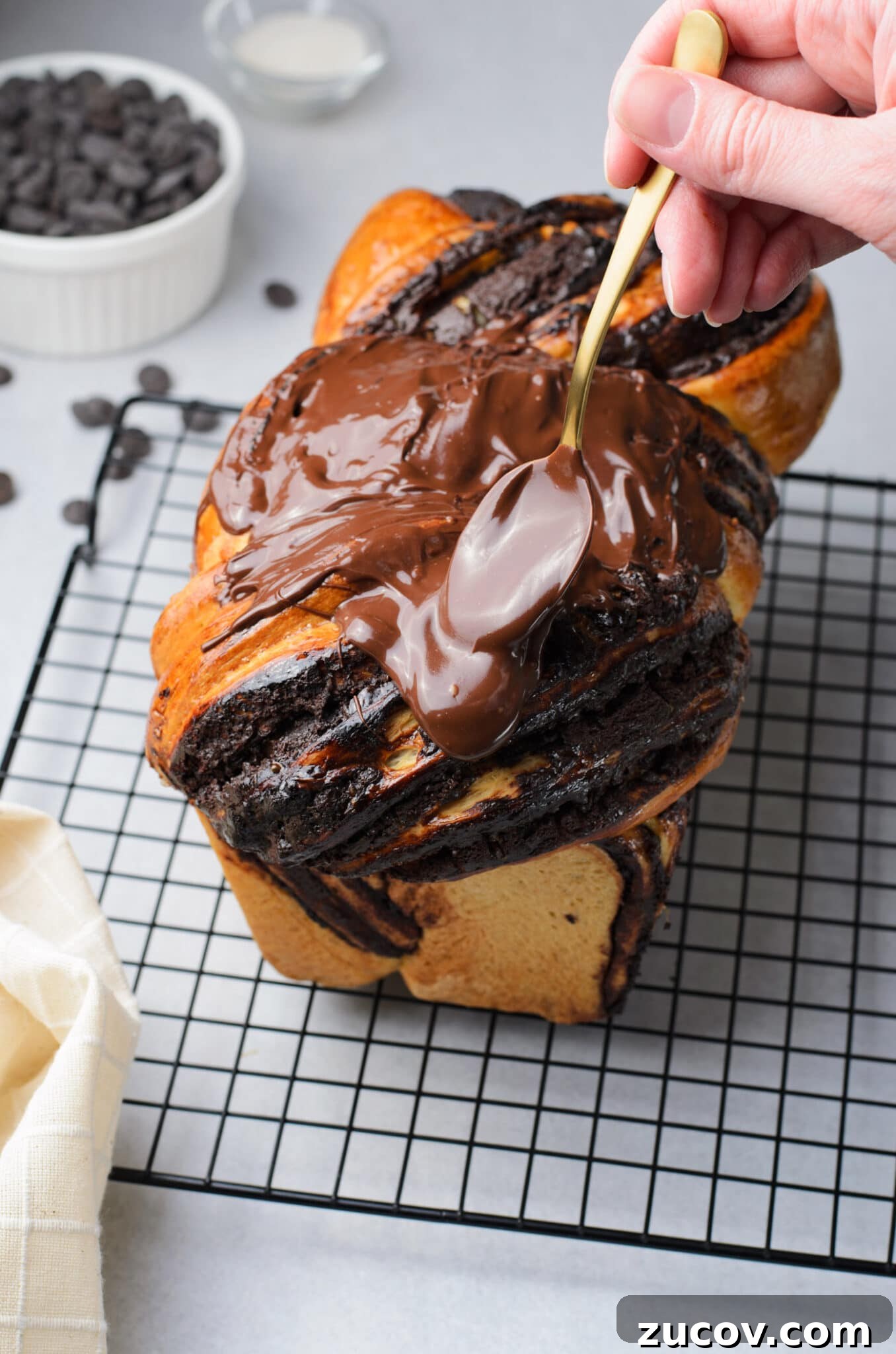 Decadent Chocolate Babka Recipe: Step-by-Step Guide 16 spooning chocolate glaze onto Chocolate Babka