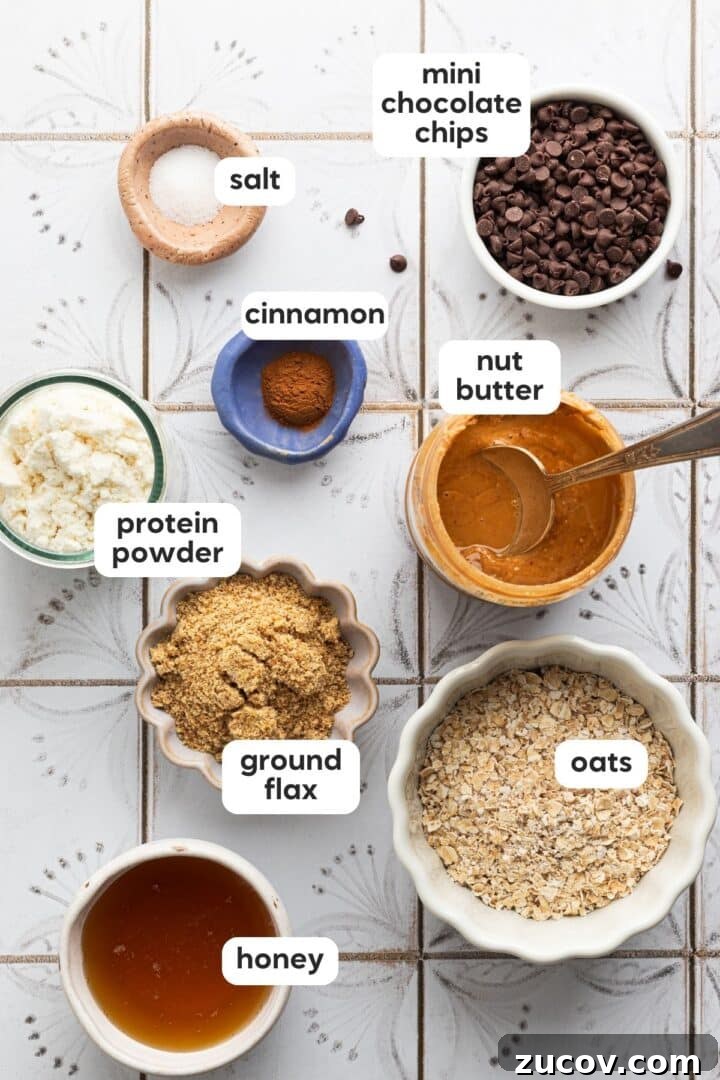 Cookie Dough Protein Balls: No-Bake Snack for Energy and Muscle 4 Ingredients for cookie dough protein balls displayed in small bowls on a white, tiled counter